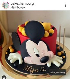 a mickey mouse cake with candles on top