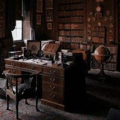 an old fashioned desk and chair in a room with bookshelves