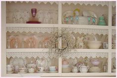 a china cabinet filled with dishes and cups