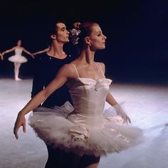 two ballerinas in white tutu and black leotards