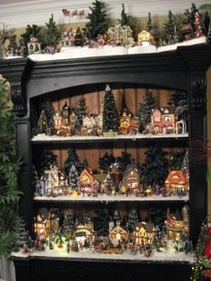 a black shelf with christmas decorations on it