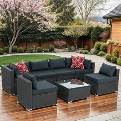 an outdoor living area with furniture and landscaping