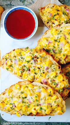 several pieces of bread on a plate with ketchup and mustard in the background