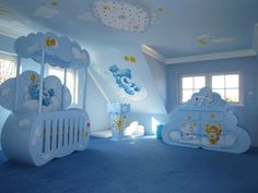 a room with blue carpet and white walls has teddy bears on the clouds painted on it