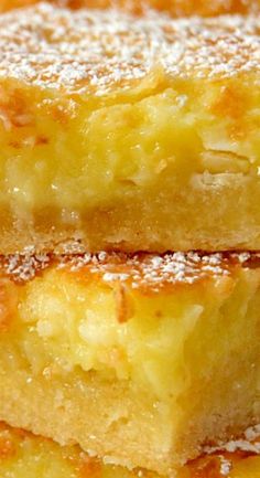 three pieces of cake sitting next to each other on top of a white plate with powdered sugar