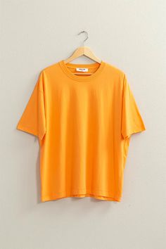 Experience style and comfort with our Violet Oversized T-Shirt! Made with a soft off-white fabric, this shirt features a fashionable oversized fit and a beautiful Orange color. Perfect for any occasion, this shirt will elevate your wardrobe and make you feel confident and stylish. Oversized Basic Solid Color T-shirt, Trendy Oversized Solid Color T-shirt, Oversized Solid Color T-shirt For Summer, Oversized Solid Color T-shirt For Everyday, Cotton Solid Color T-shirt For Loungewear, Trendy Boxy Fit Drop Shoulder T-shirt, Relaxed Fit Solid Color T-shirt For Loungewear, Oversized Plain T-shirt For Summer, Oversized Orange Crew Neck Top