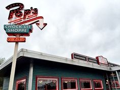 an old neon sign on top of a store