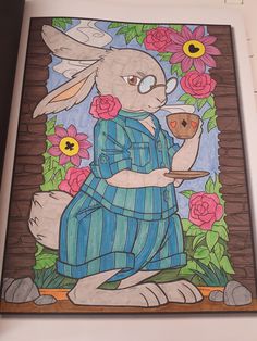 a drawing of a rabbit holding a cup