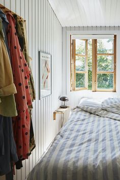 a bed sitting in a bedroom next to a window