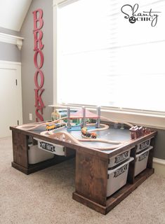 a toy train table in the corner of a room