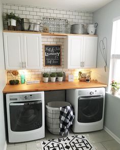 a washer and dryer sitting in a kitchen next to each other on top of a rug