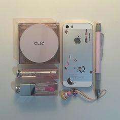 the contents of a cell phone and other items are laid out on a white surface