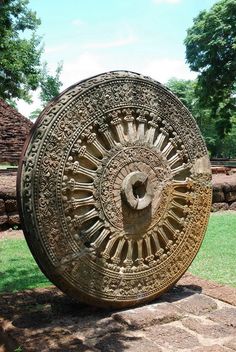 a large circular object sitting on top of a stone slab