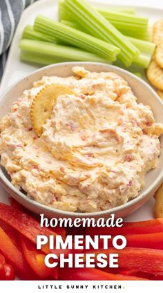 homemade pimentoo cheese in a bowl surrounded by vegetables and crackers