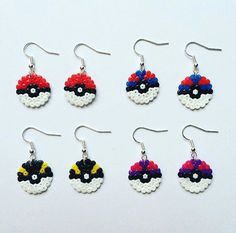 six pairs of pokemon earrings are shown in different colors and sizes, including red, yellow, blue, white, and black