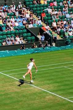 a female tennis player is running across the court with her racquet in hand