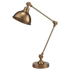 an antique brass desk lamp on a white background