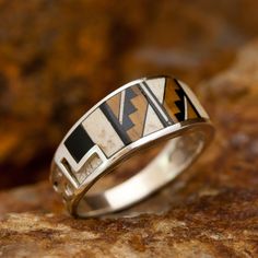 This beautiful Sterling Silver Ring, as part of the Kayenta collection, features Black Jade, Tiger's Eye, and White Jasper. Choose Ring Size. Ring Width: 3/8"; Shank Width: 3/16" The ring is designed by David Rosales, one of the finest contemporary Southwest Artists in the world. He is the founder and co-owner of Supersmiths, Inc. of Gallup, NM. Each ring is custom made and carries a lifetime guarantee. Please Choose Ring Size from the above menu. In the event that this item is in stock in our P Man Closet, Raw Diamond Jewelry, Indigenous Fashion, White Jasper, Contemporary Southwest, Male Jewelry, Hammered Silver Jewelry, Dolphin Jewelry, Silver Jewelry Diy