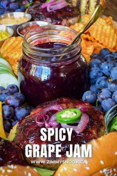 A jar of grape jam in a tray with a burger, grapes, chips and cucumbers. Jalapeno Grape Jelly Recipe, Grape Preserves Recipe, Concord Grape Recipes, Grape Jam Recipe, Fall Canning, Jalapeno Jelly Recipes, Savory Jam Recipes, Pickled Fruit