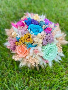 a bouquet of flowers sitting in the grass