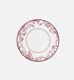 a red and white plate sitting on top of a table