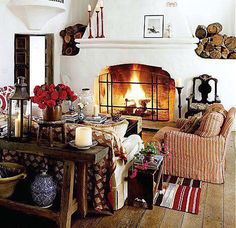 a living room filled with furniture and a fire place in the middle of a room