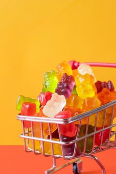 a shopping cart filled with lots of gummy bears