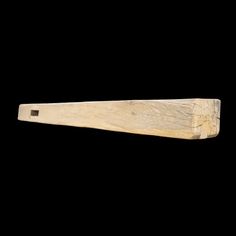 a piece of wood is shown against a black background