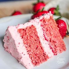 a slice of red velvet cake on a plate with strawberries