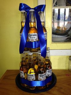 there is a display made out of beer bottles on a table with a blue ribbon