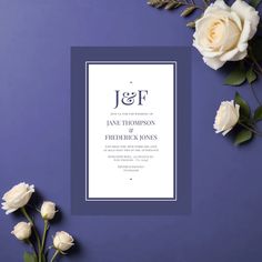 a wedding card with white roses and greenery on a purple background next to it