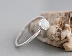 Want 20% off this item? Go here to claim your coupon code! https://pintody.com/pages/discounts This Textured Stack-able opal ring features a 5mm simulated opal gemstone. A perfect opal stacking ring for a slim look for stacking gemstone rings together for a dramatic look. Wear alone or stack with other silver stacking rings and bands. Add other gemstones for a mothers ring and birthstone options. The hammered texture gives the ring a shimmery look for your most dressed affair. A delicate ring wi Everyday Stackable Opal Ring, Adjustable Stackable Opal Open Ring, Simple Adjustable Rings With Ethical Gemstones, Adjustable Stackable Moonstone Promise Ring, Minimalist Stackable Opal Ring Gift, Adjustable Stackable Moonstone Ring Gift, Dainty Stackable Opal Ring Gift, Minimalist Opal Ring With Bezel Setting As Gift, Minimalist Stackable Jewelry With Round Stone