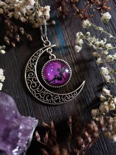 "Boho Fairy moon necklace with an adorable fairy sitting on a beautiful purple starry night background. You can choose your finish of Bronze or Silver. ➳ Moon measures approximately 2\"x2\". ➳ Reference photo chart to determine the length that suits you. ➳ Bronze chain is lead free metal alloy. ➳ Silver chain is stainless steel and suitable for those with allergies to certain metals. ̩̩͙✩*̩̩͙*˚＊ ̩̩͙✩*̩̩͙*˚＊ ̩̩͙✩*̩̩͙*˚＊ ̩̩͙✩*̩̩͙*˚＊ ̩̩͙✩*̩̩͙ 🌙 The Lunarly Lotus is a new shop but I have been a sel Handmade Purple Fantasy Necklaces, Handmade Purple Fantasy Necklace, Whimsical Purple Jewelry For Gifts, Purple Fairycore Jewelry For Gifts, Fairycore Purple Jewelry As A Gift, Handmade Purple Fairycore Jewelry, Purple Fairycore Jewelry For Jewelry Making, Silver Fairy Grunge Necklace As A Gift, Silver Fairy Grunge Necklace For Gift