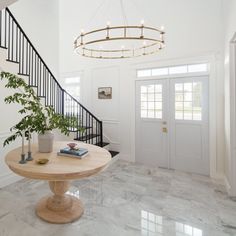 a foyer with marble floors and white walls