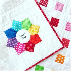 the quilts are colorful and have different designs on them, including one with a name