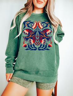 "Scandinavian Sweater, Norwegian Folk Art, Cottage Core Sweater, Comfort Colors®, Scandinavian Gift, Aesthetic Sweatshirt, Boho Sweatshirt WELCOME TO MY STORE! Comfort Colors® brand sweatshirt is the symbol of casual comfort and casual style. Made from high-quality, pre-shrunk cotton, what sets the Comfort Colors® sweatshirt apart is the brand's unique garment dyeing process, which gives it a distinctive, vintage-inspired look. The attention to detail in the stitching and construction reflects t Green Graphic Print Sweater For Spring, Printed Green Tops For Winter, Green Crew Neck Sweatshirt With Graphic Print, Printed Relaxed Fit Sweatshirt For Fall, Green Bohemian Top With Graphic Print, Cotton Sweatshirt With Printed Relaxed Fit, Printed Crew Neck Casual Sweatshirt, Cotton Relaxed Fit Printed Sweatshirt, Casual Printed Crew Neck Sweatshirt