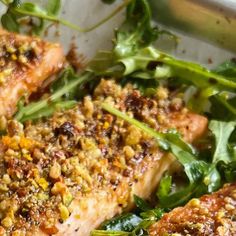 some fish and greens on a white plate