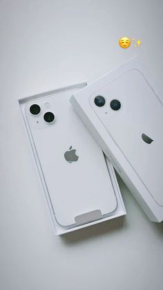 two white iphones sitting next to each other