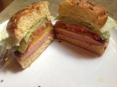 a cut in half sandwich sitting on top of a white plate