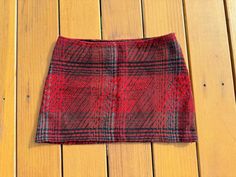 Beautiful red plaid with black and blue wool mini skirt. Lined. 45 percent wool, 15 percent mohair, polyacrylic. Fabric woven in Italy. From the designers of Parachute clothing, Harry Parnass and Niccla Pelly. Circa 1990's. Water it and feel fierce. Red Lined Mini Skirt, Red Mini Pleated Lined Skirt, Retro Red Mini Skirt, Retro Plaid Mini-length Bottoms, Retro Plaid Mini Skirt Bottoms, Wool Mini Skirt, Womens Skirts, Blue Wool, Red Plaid