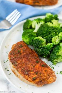 a white plate topped with meat and broccoli