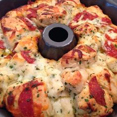 a pizza with cheese and pepperoni in a bundt cake pan