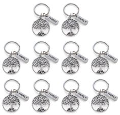 six metal key chains with trees and words on them, all in different shapes and sizes