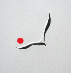 a red dot is on the white paper with black lines and a long tail in the shape of a bird