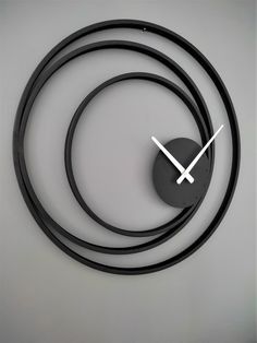 a clock that is on the side of a wall with a black circle around it