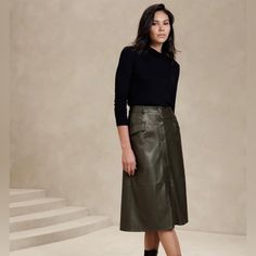 -Vegan Leather Skirt, Size S, In Olive Green Color -Lightweight, Smooth And Soft -Button Front Closure -Belt Loops -Front Pockets -Waist Darts - High Waist -Full Hem -Fully Lined -Base Fabric: 100% Rayon -Outer Coating:Polyruethane Hunter Green Leather Skirt, A Line Leather Skirt Outfit, Leather A Line Skirt Outfit, Green Leather Skirt Outfit, Midi Leather Skirt Outfit, Outfit With Leather Skirt, Leather Midi Skirt Outfit, Midi Leather Skirt, Green Leather Skirt