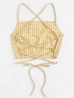 a yellow and white checkered apron tied up to the side with two ties around it