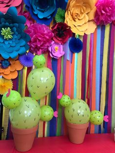 colorful paper flowers and fake cactuses are on display