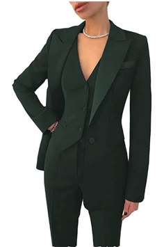 a woman in a green suit posing for the camera with her hands on her hips