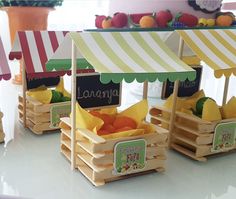 three wooden crates with fruit in them sitting on a table